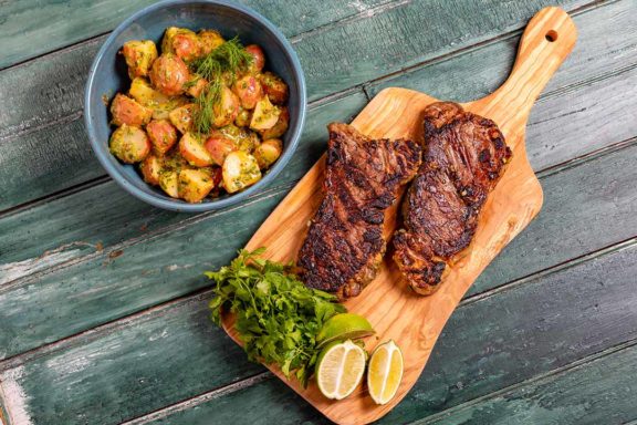 marinated steak tips with herby potato salad