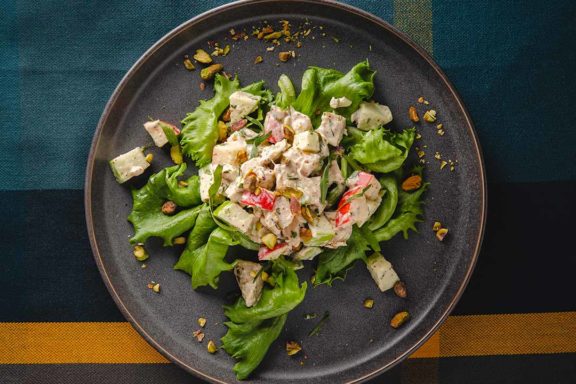 tarragon and apple chicken salad on a bed of greens