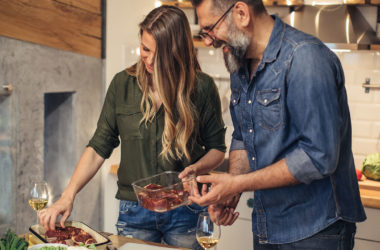 couple preparing steak dinner in kitchen on weeknight