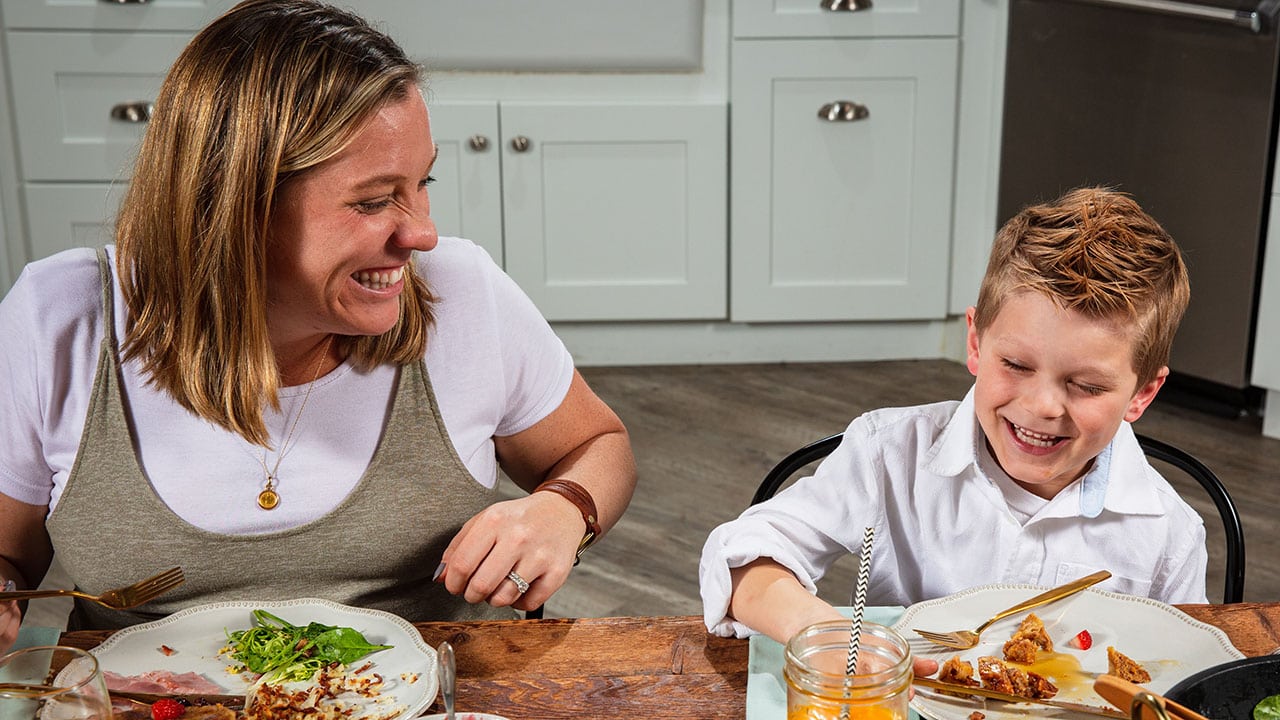 mom and son laughing at meal