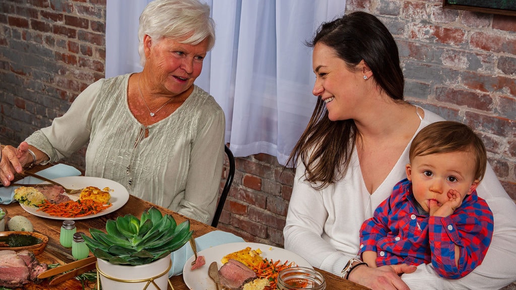 grandmother, mom, and child enjoying dinner