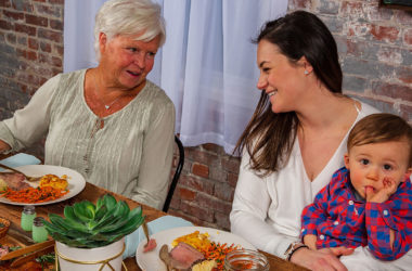 grandmother, mom, and child enjoying dinner
