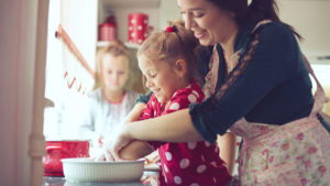 mom teaching kids to cook