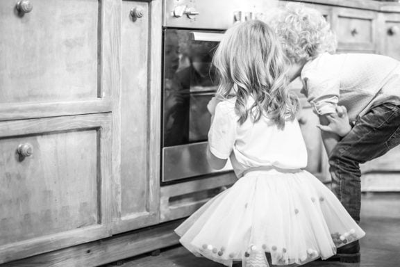 kids looking in oven