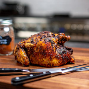 whole roasted chicken on a chopping board