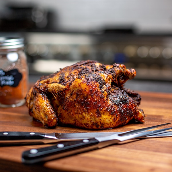 whole roasted chicken on a chopping board