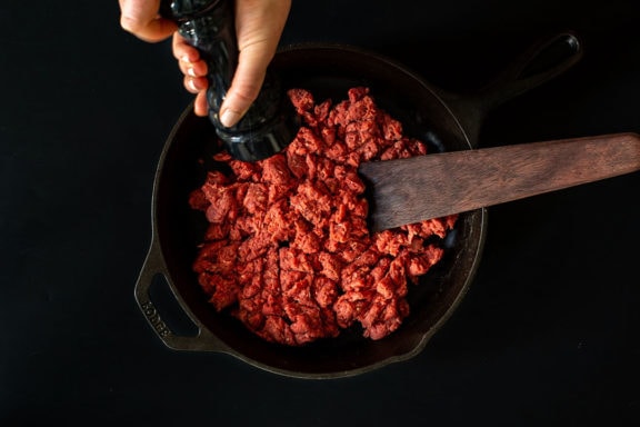 ground bison in cast iron pan