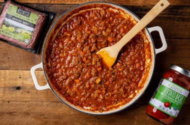 Fennel bolognese in a pot next to ground beef and marinara sauce