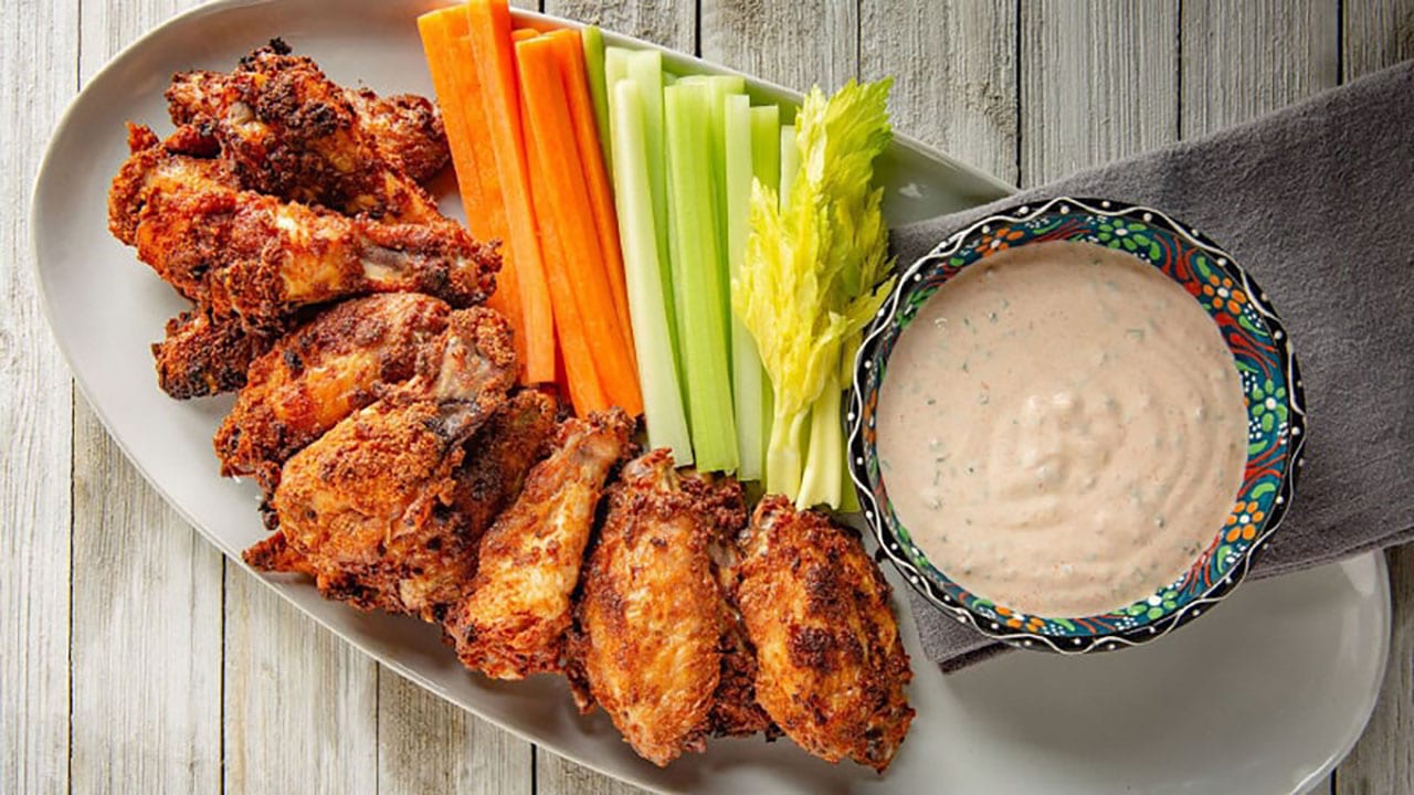 chicken wings with carrots, celery, and sauce