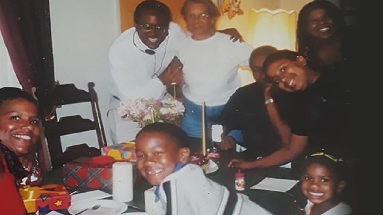 Kids and adults standing around the dinner table