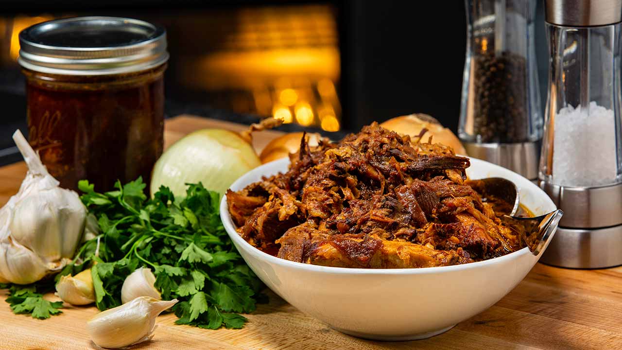 BBQ pulled pork in a bowl surrounded by ingredients