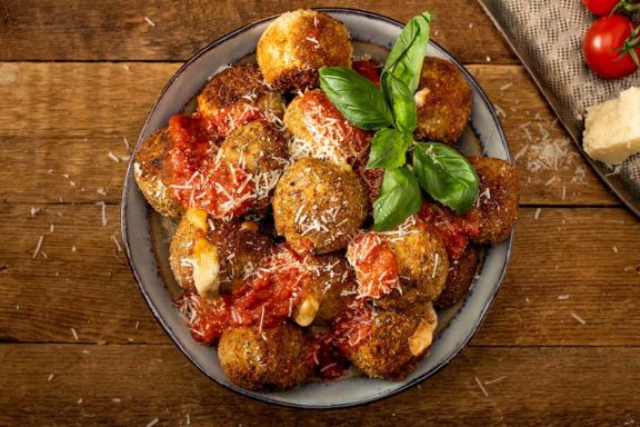 Chicken Parmesan meatballs stacked in a bowl