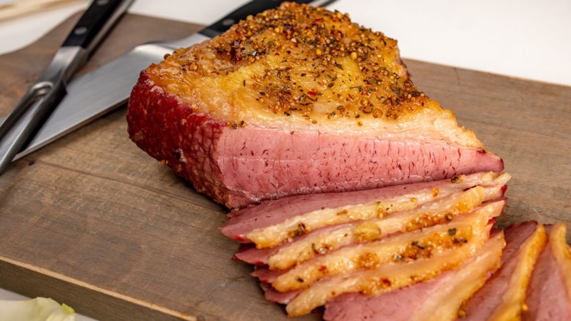 Corned beef cooked and sliced on a cutting board