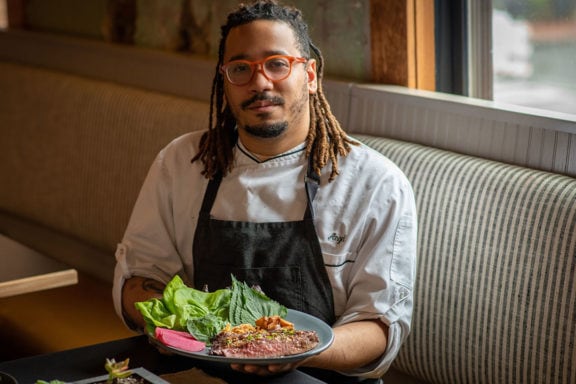 angel barreto of anju with his flank steak ssam board