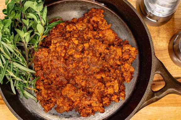 ground beef in pan with herbs