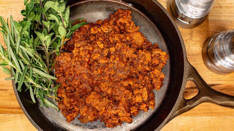 ground beef in pan with herbs