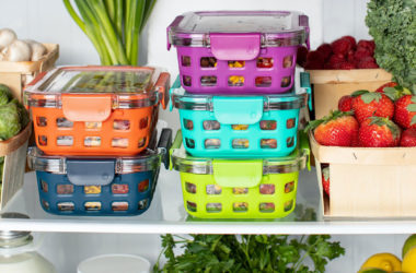 Containers, vegetables, and fruits sitting in a refrigerator