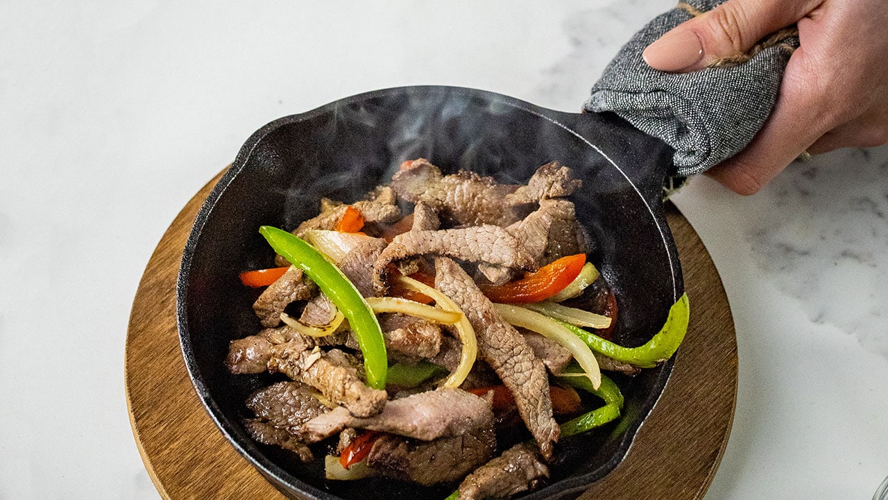 ButcherBox Complete beef fajita strips in a cast-iron pan