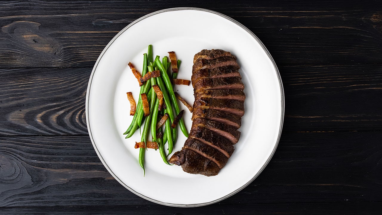 ButcherBox Complete Montreal Sirloin Cap on a plate with green beans