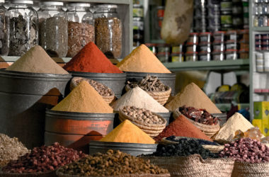 bins and jars filled with spices at a market