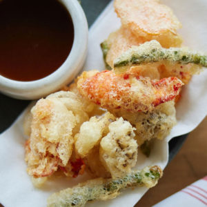 lobster and asparagus tempura next to a ramekin of ponzu sauce