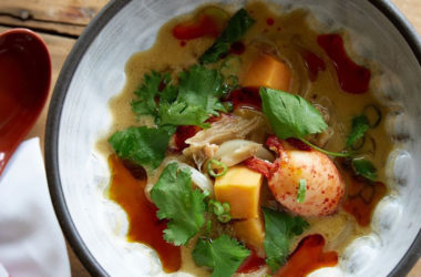 green curry lobster stew in bowl with spoon