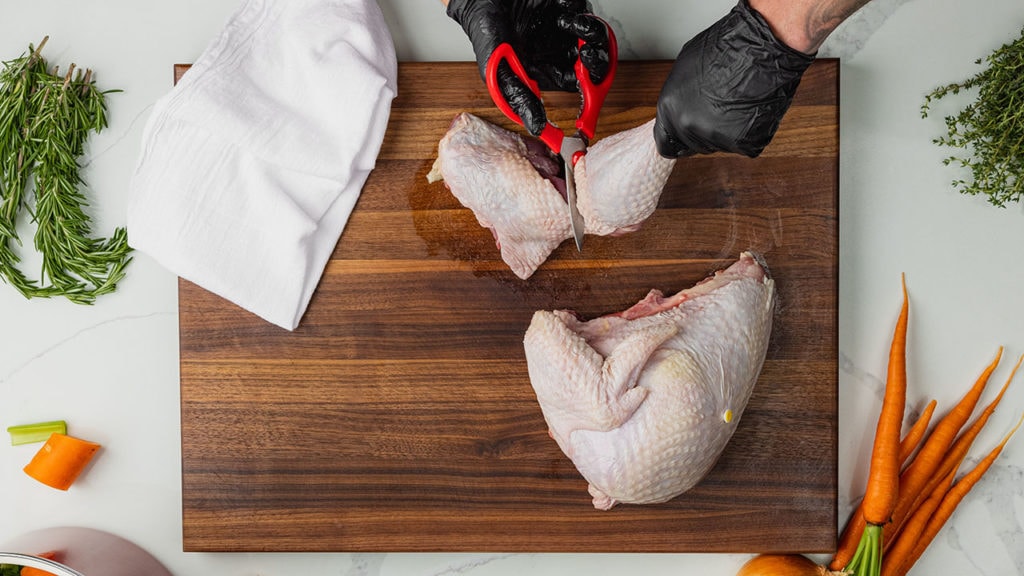 removing a turkey leg from a turkey thigh