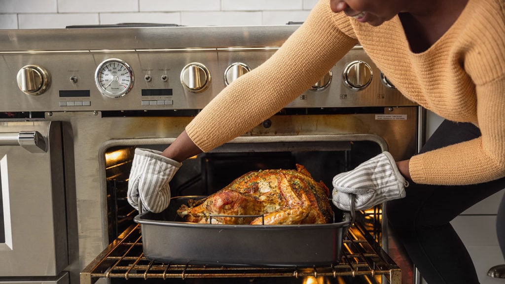 taking cooked turkey out of oven
