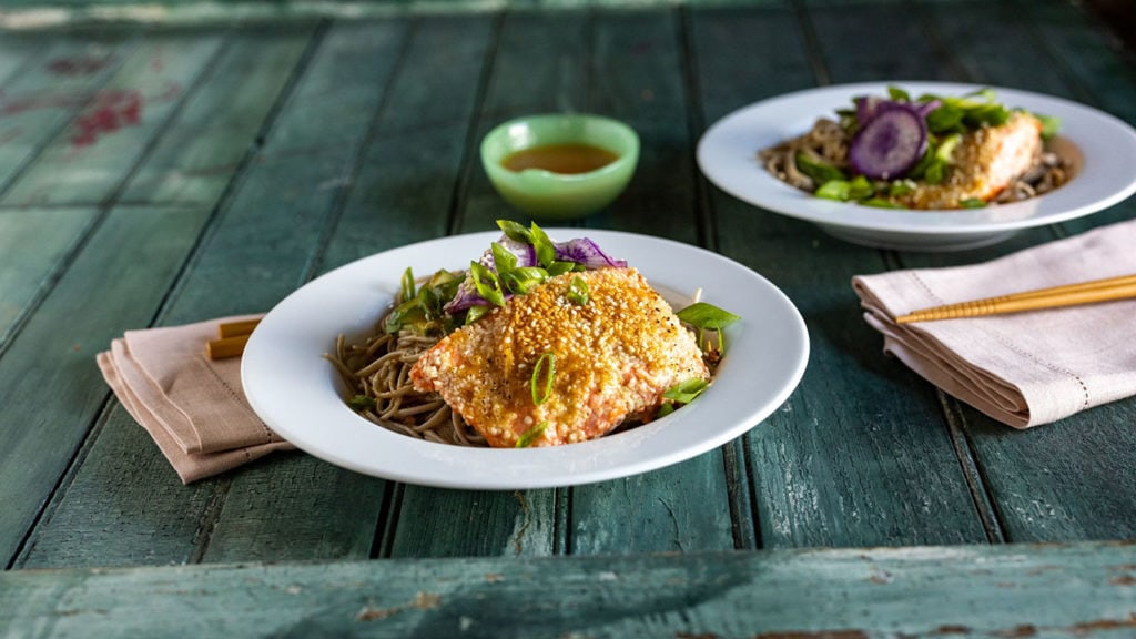 cooked salmon in a dish on a green table