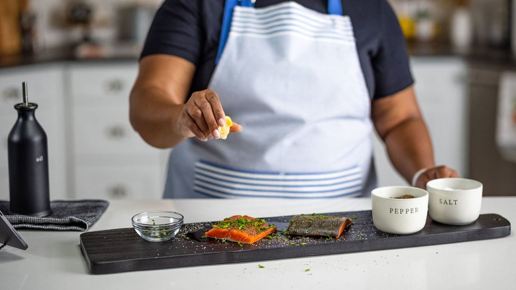 squeezing a lemon on seafood