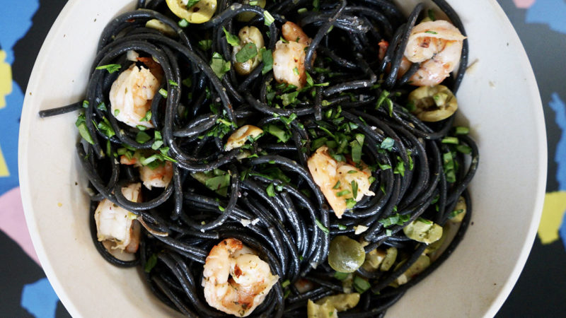 black squid pasta with green olives and shrimp