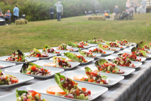 multiple salads lined up for a group cookout