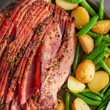 ham with snap peas and potatoes on a plate