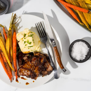 braised brisket on a plate with carrots and butter
