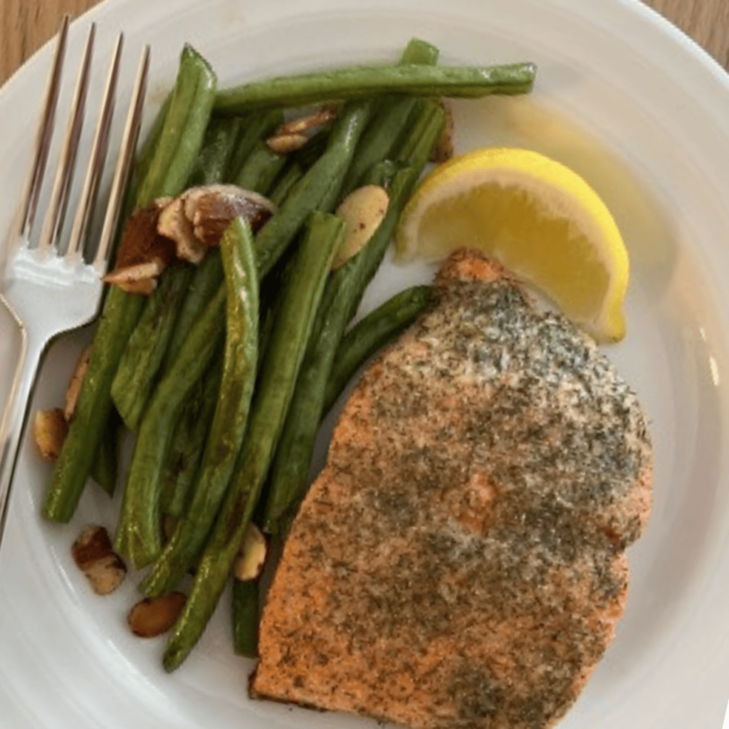 salmon beans and lemon in a plate
