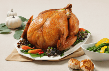 Thanksgiving table with turkey and side dishes.