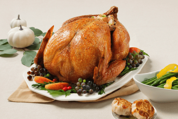 Thanksgiving table with turkey and side dishes.