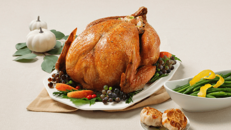 Thanksgiving table with turkey and side dishes.
