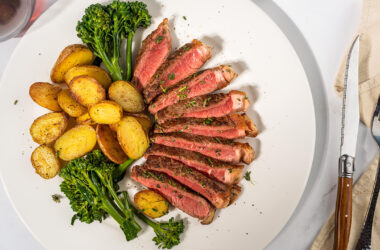 NY strip with potato and vegetable on a plate