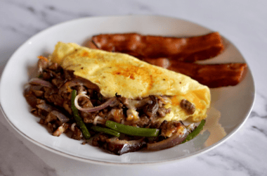 omelette next to a hotdog on a plate