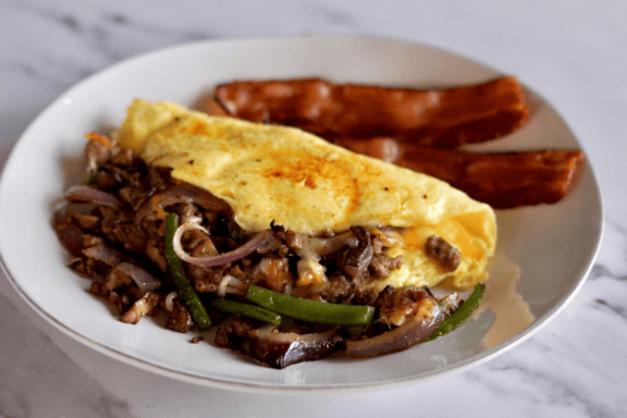 omelette next to a hotdog on a plate