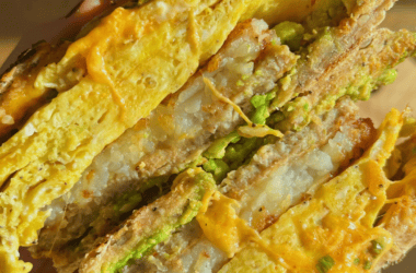 bagel sandwich filled with sausage patty hash brown patty and egg