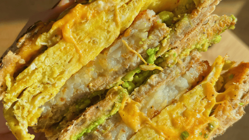 bagel sandwich filled with sausage patty hash brown patty and egg