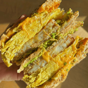 bagel sandwich filled with sausage patty egg and hashbrown patty