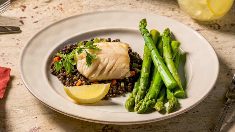 sablefish with asparagus on a plate